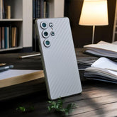 Smartphone with White Carbon Fiber mobile skin on a dark surface